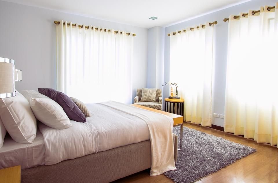 Bright, tidy bedroom with soft curtains – preparing a peaceful room for prayer and sleep