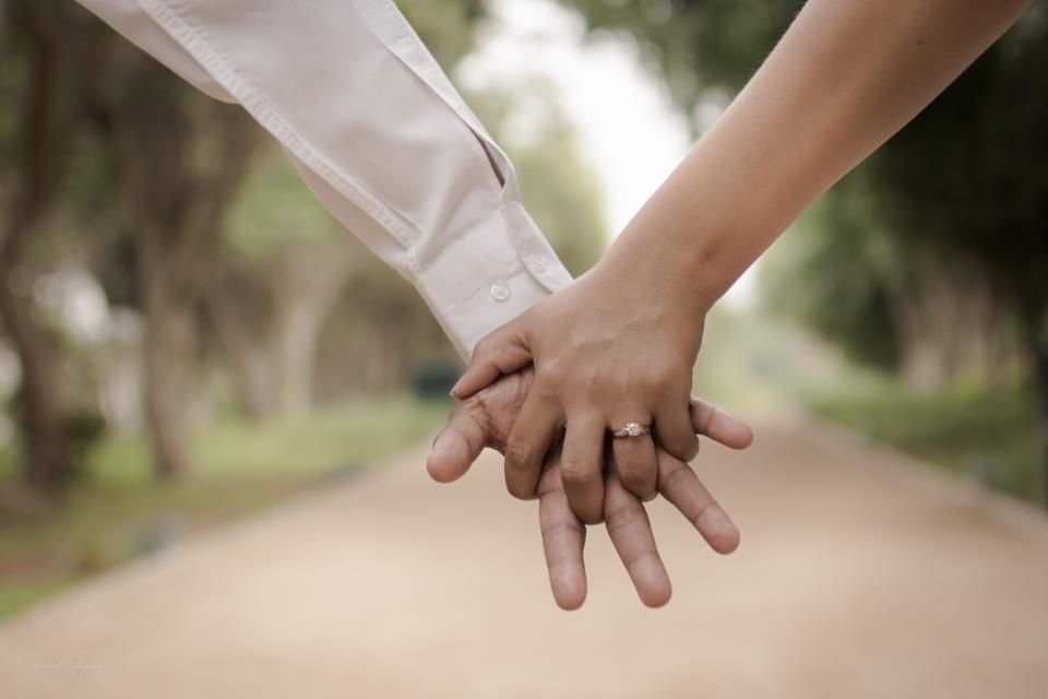 Couple holding hands on a tree-lined path, engagement ring visible – hope for a God-honouring marriage