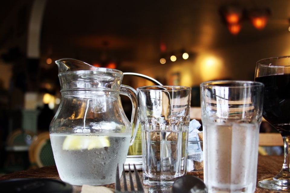Jug and glasses of water on a table – drinking water safely during a 3-day Esther fast