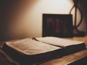 Open Bible on a table in warm lamplight – a quiet place for midnight prayer points with Bible verses