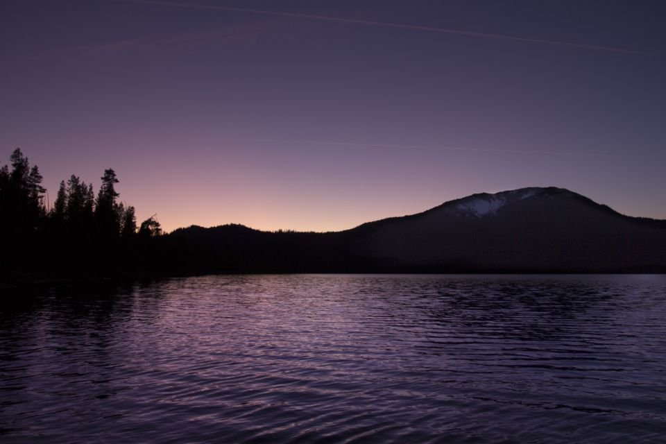 A quiet lake under a purple evening sky – lying down in peace at the end of the day (Psalm 4:8)