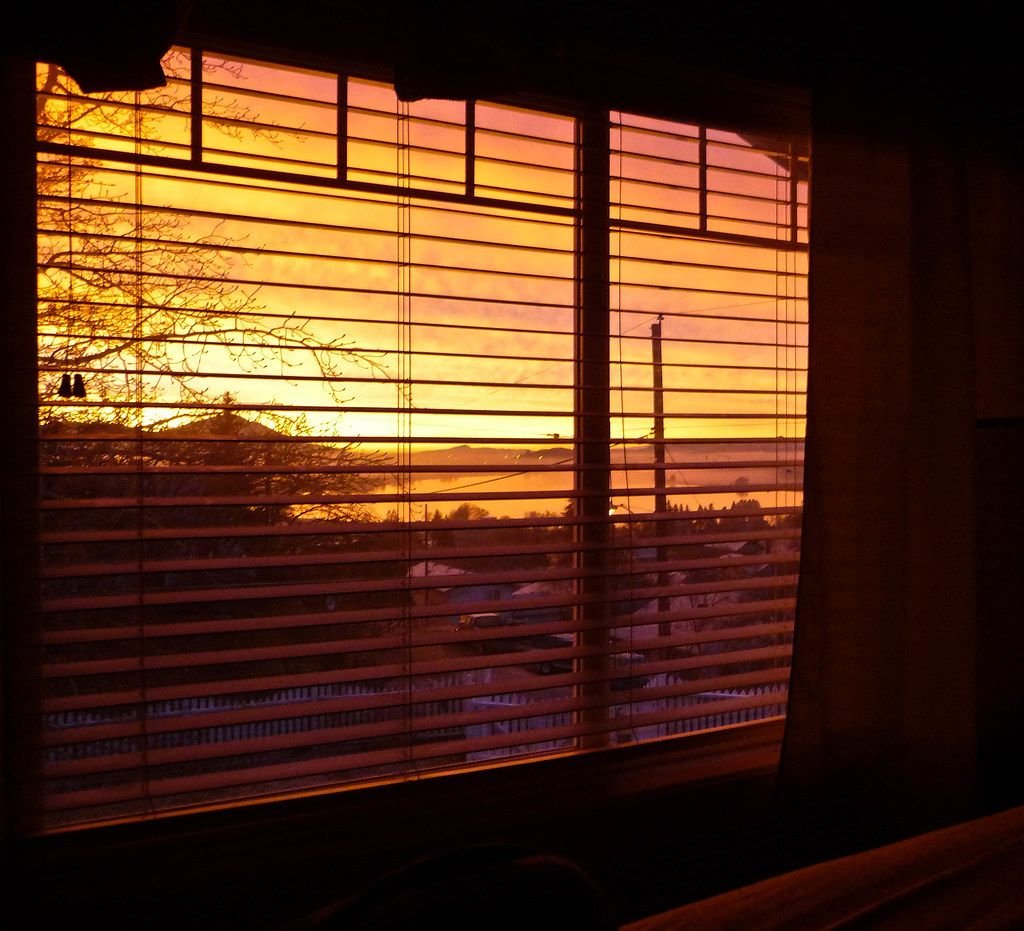 Sunrise glowing through a bedroom window – hope and peaceful sleep after troubling dreams