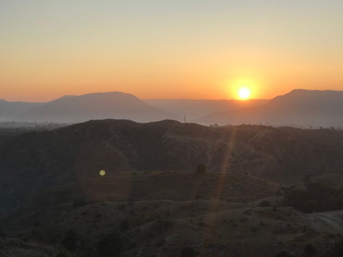 The sun rising over hills and mountains at dawn – a picture of new mercies and God's divine favour