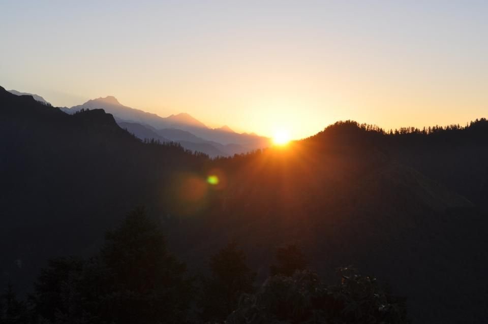 The sun rising over a line of hills – waking to a new morning after a peaceful night