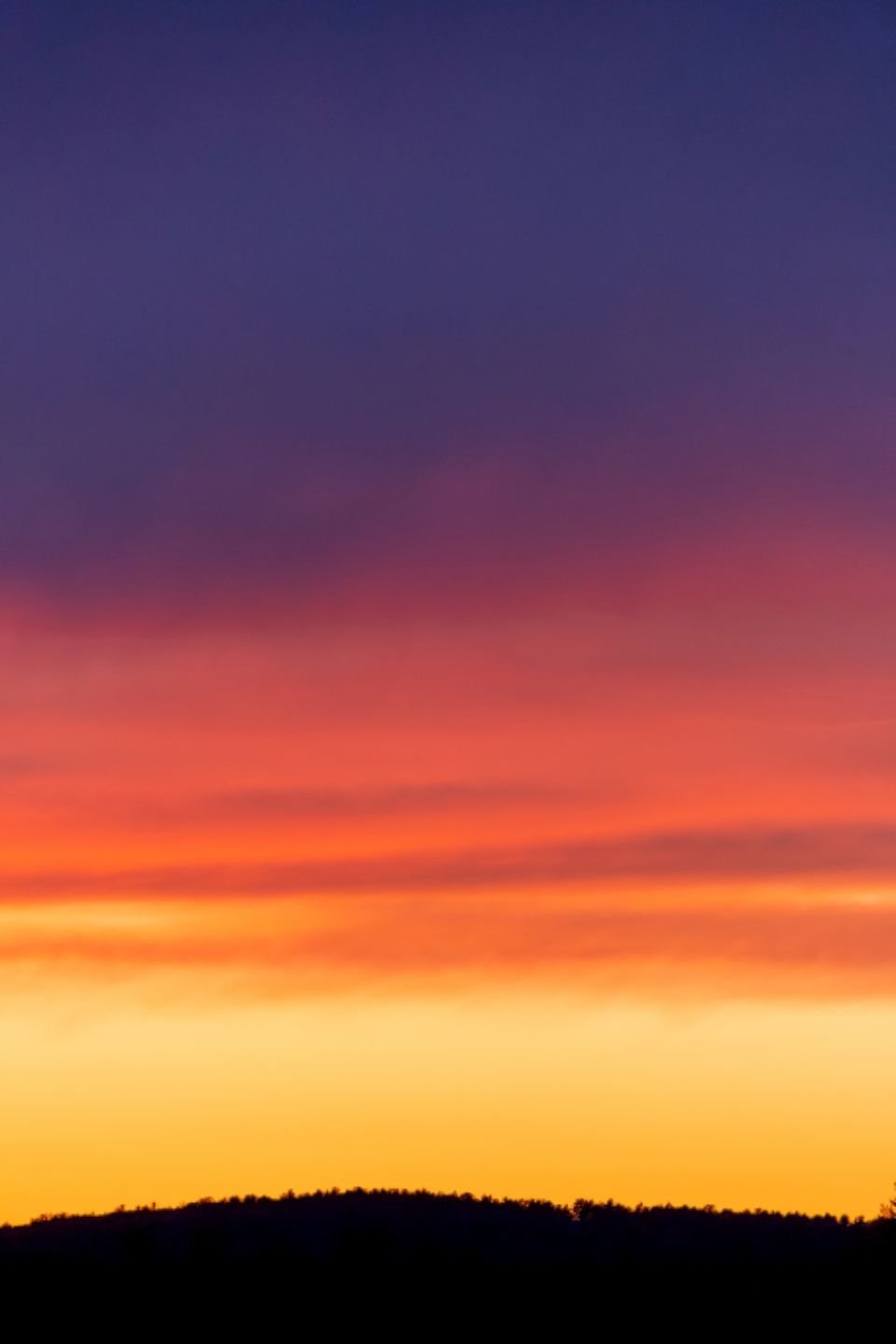 A colourful sunrise over a mountain ridge – thanking God for each new day of life