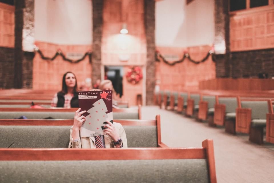 Woman reading quietly in a church pew – renewing the mind with Scripture after a soul tie