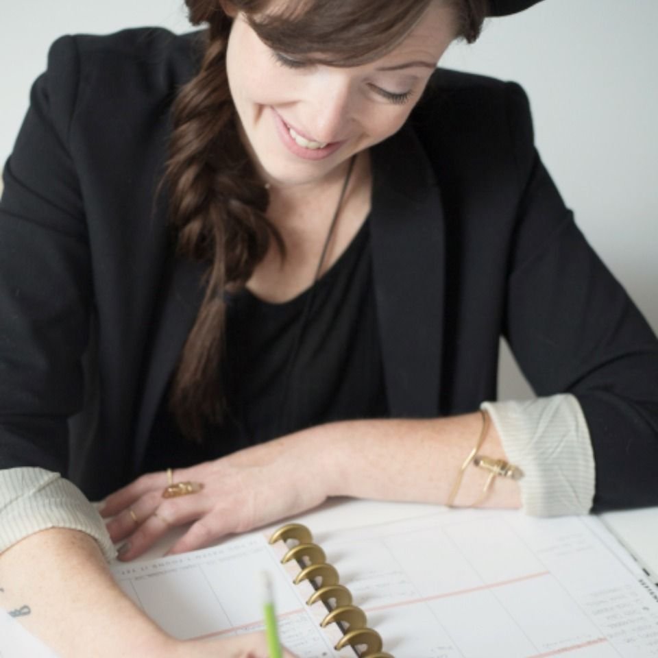 Woman writing in a notebook – writing down a snake dream so it can be tested by Scripture