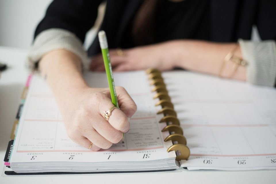 Hand writing in a notebook – writing down a dream and praying over it before acting